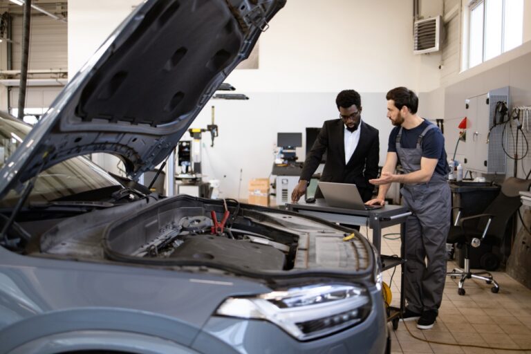 Service advisor reviewing a FIRFT comeback report for repeat repair visits