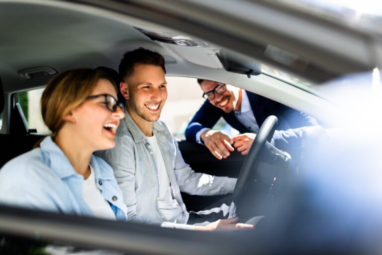 Dealer group executives comparing CSI scores during a dealership acquisition review
